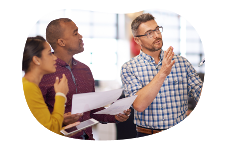 IT project manager going over a project plan with a team. IT project manager going over a project plan with a team.