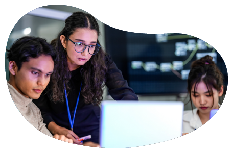 Employees working on a laptop in an SaaS server room.