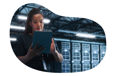 SaaS business owner working on a tablet in a server room.