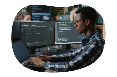 Software developer looking at code on a monitor.