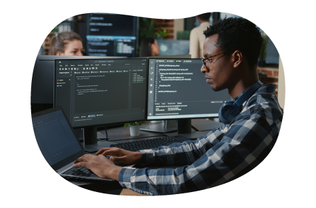 Software developer looking at code on a monitor.