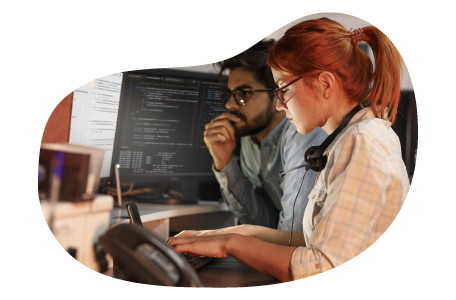 Software developers writing programming code on a computer.