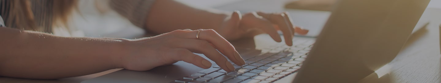 A technical writer typing on a laptop. A technical writer typing on a laptop.