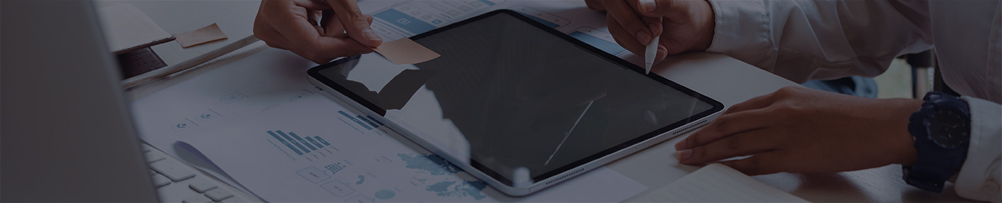 Web designer pointing to a prototype on an iPad.