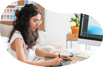 Graphic design professional creating an illustration at their desk for a client.