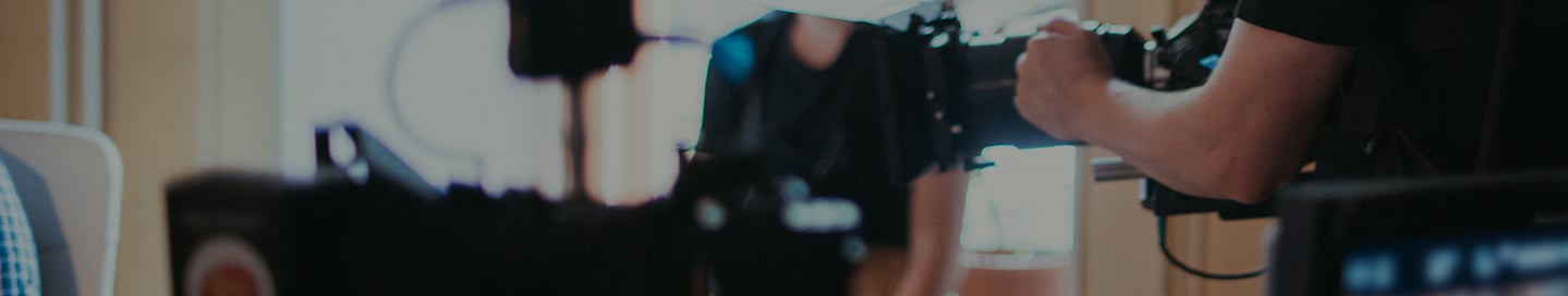 A camera operator on the film set for a commercial. A camera operator on the film set for a commercial.