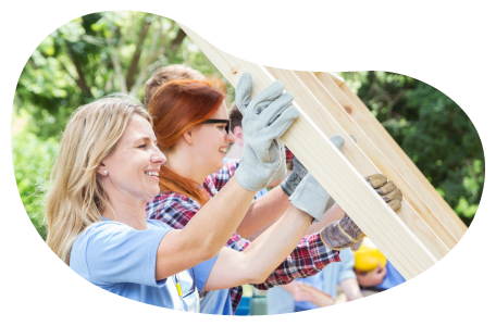 A group of volunteers helps build a home. A group of volunteers helps build a home.