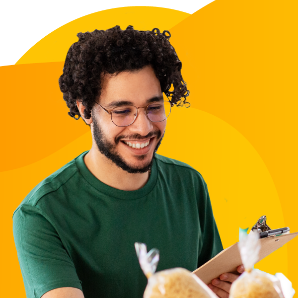 A volunteer inventories items on a clipboard.