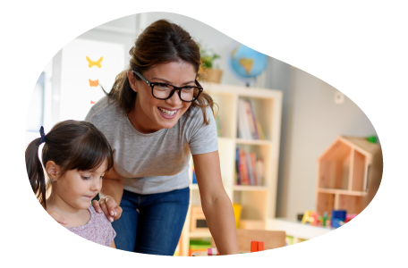 A childcare center teacher helping a child.