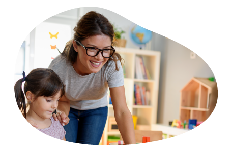 A childcare center teacher helping a child. A childcare center teacher helping a child.