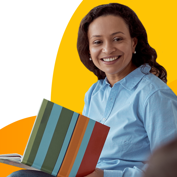 A childcare center teacher reading a book.