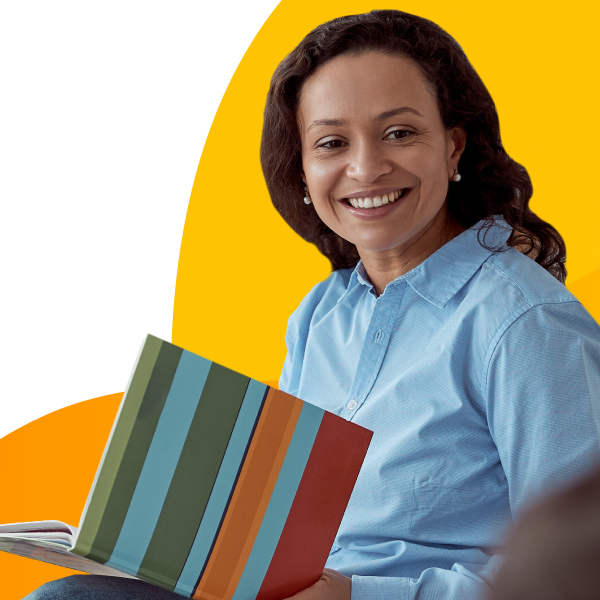 A childcare center teacher reading a book.