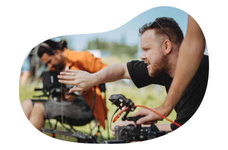 A photographer taking a close up shot during an outdoor shoot A photographer taking a close up shot during an outdoor shoot