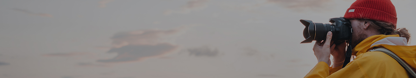 A photographer takes a picture of a hazy sunset. A photographer takes a picture of a hazy sunset.