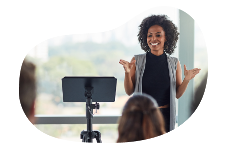 A public speaker addressing a conference room for a presentation.