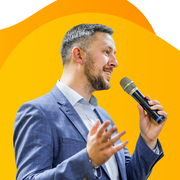 A public speaker giving a keynote presentation with a microphone in hand.