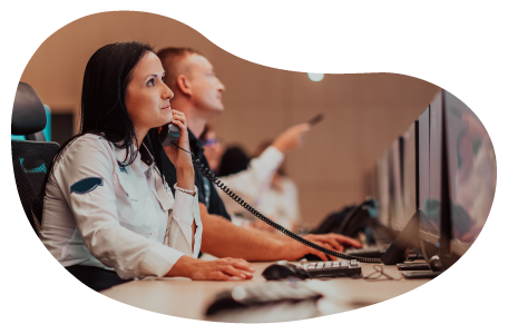 Security guard monitoring premises on a computer.