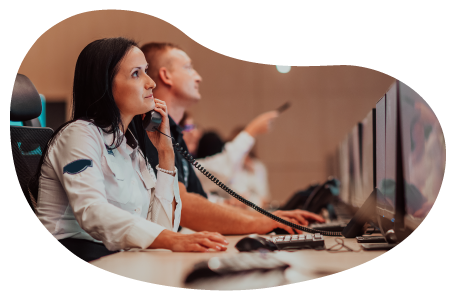 Security guard monitoring premises on a computer. Security guard monitoring premises on a computer.