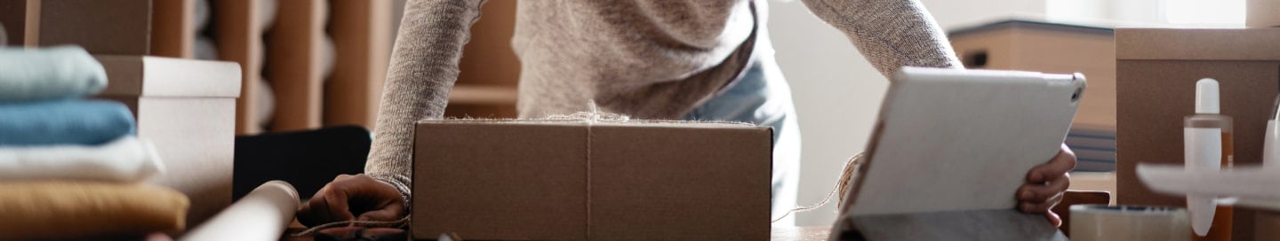 An Amazon seller packs up an item for shipment. An Amazon seller packs up an item for shipment.