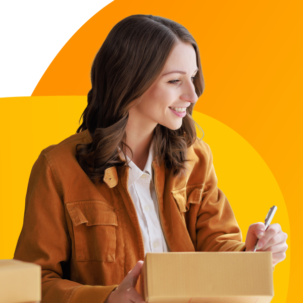 An Amazon seller writes an address on a package.