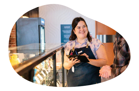 An employee at a cannabis dispensary chats with a customer.