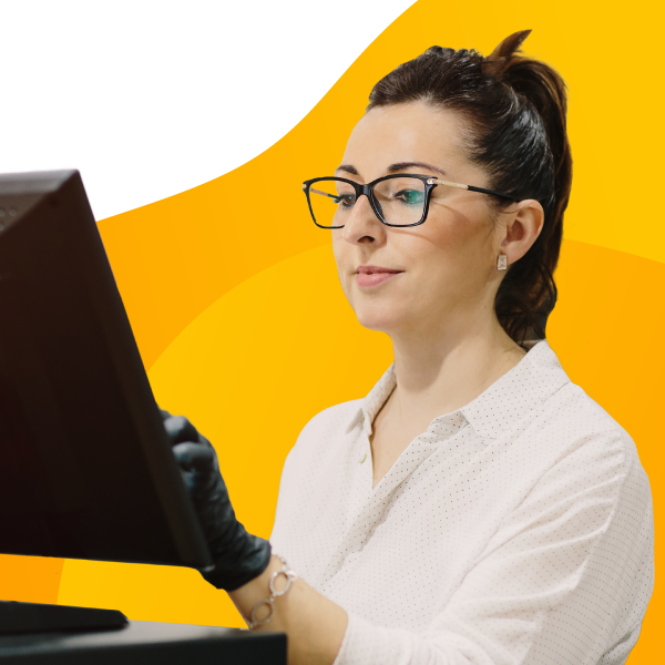 A dispensary employee checks inventory on a monitor.