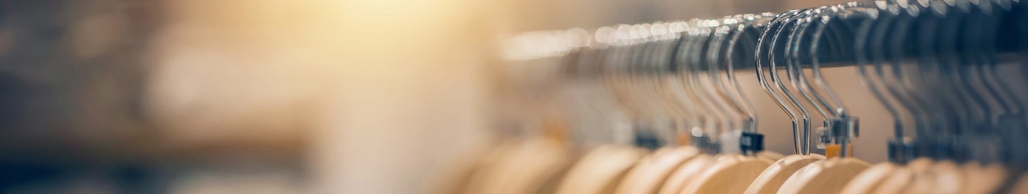 Clothing on hangers in a clothing store display.