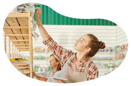 Convenience store worker stocking shelves