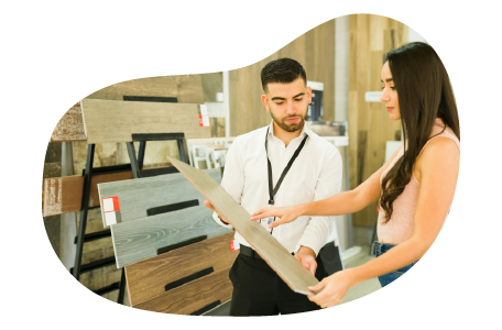 A furniture store salesperson working with a customer.