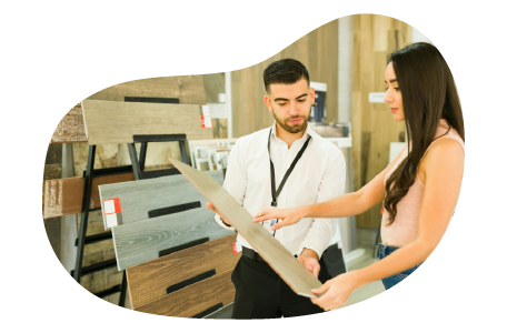 A furniture store salesperson working with a customer. A furniture store salesperson working with a customer.