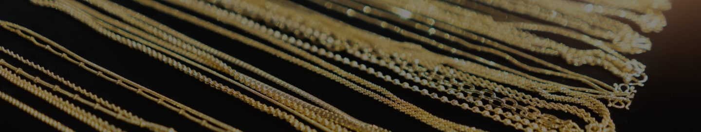A jewelry store display of gold necklaces. A jewelry store display of gold necklaces.