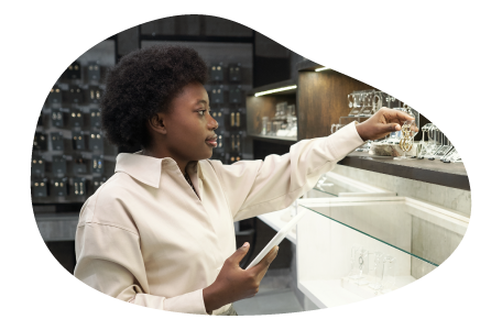A jewelry store clerk inventorying products.