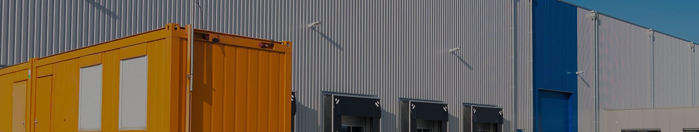 A tractor-trailer at a warehouse's loading bay. A tractor-trailer at a warehouse's loading bay.
