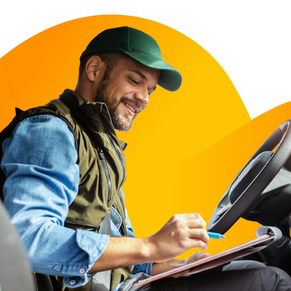 A tow truck driver behind the wheel with a clipboard.