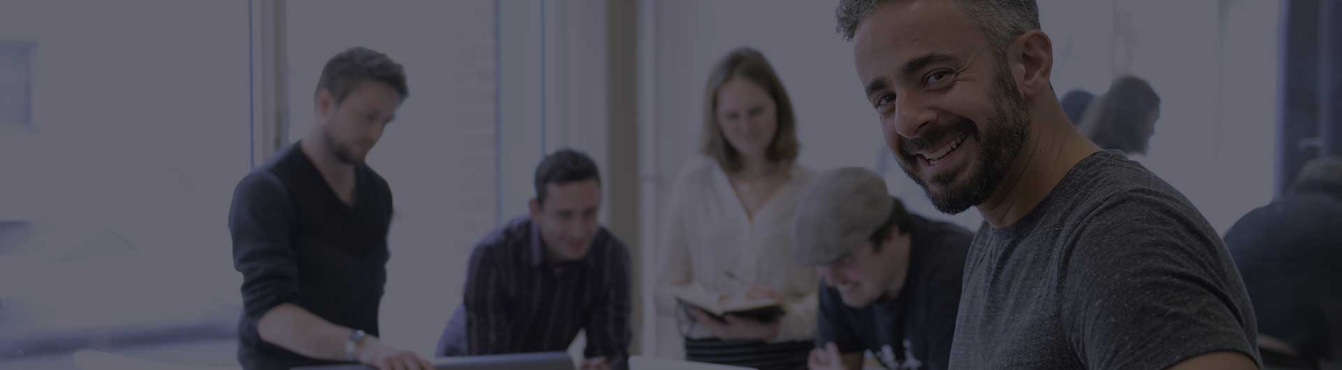 Small business owner working with team on a creative project.