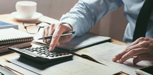 Business owner using a calculator