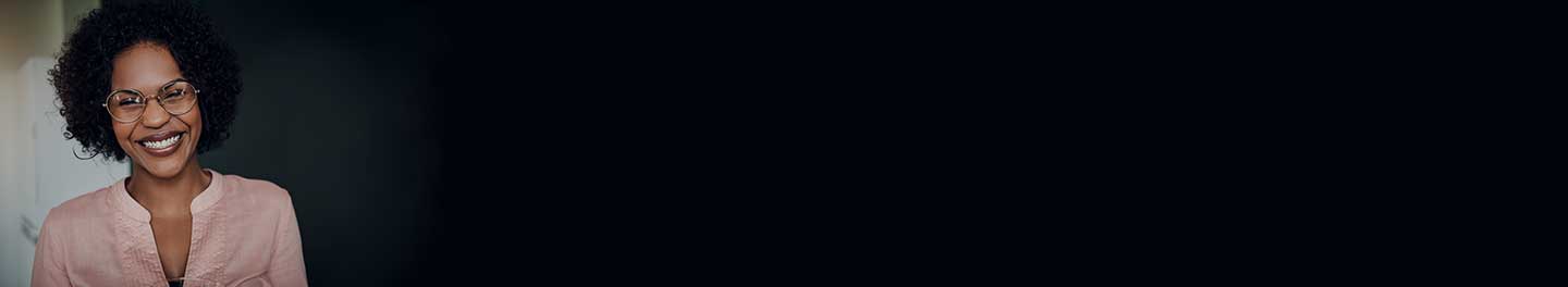 Woman smiling in a pink shirt.