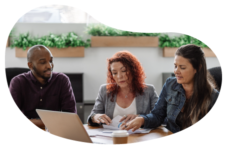 Two business owners reviewing their business owner's policy on a laptop with an insurance agent.. Two business owners reviewing their business owner's policy on a laptop with an insurance agent..