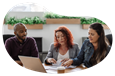 Two business owners reviewing their business owner's policy on a laptop with an insurance agent..
