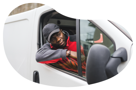 Person in a company van driving packages for delivery. Person in a company van driving packages for delivery.