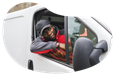 Person in a company van driving packages for delivery.
