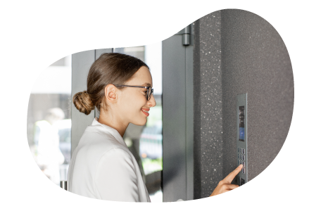 A small business owner setting an alarm inside their storefront.