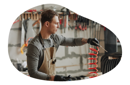 A contractor repairing an appliance with a specialized tool. A contractor repairing an appliance with a specialized tool.