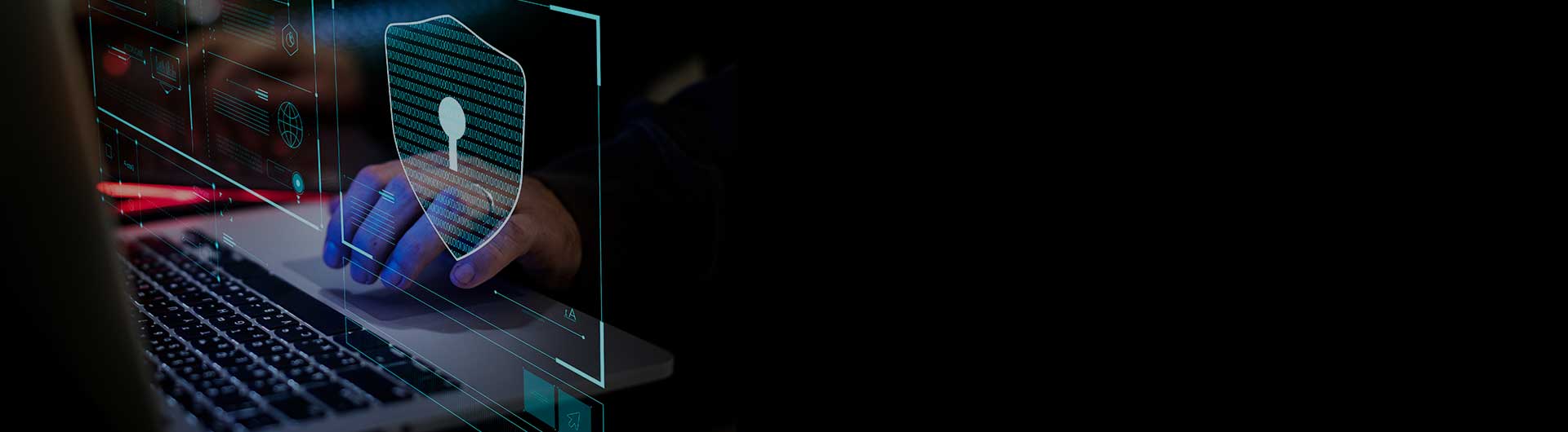 Person typing on laptop with encryption symbol.