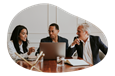 A company director discussing business operations with other board members.