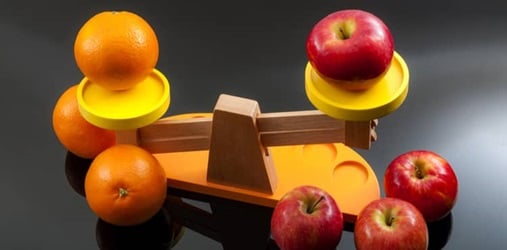 Apples and oranges balanced on a scale