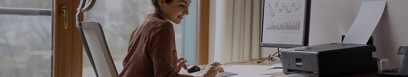 A woman calculating her business's numbers on the computer