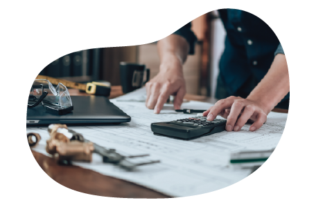 A small business owner calculating the cost of workers' compensation insurance. A small business owner calculating the cost of workers' compensation insurance.