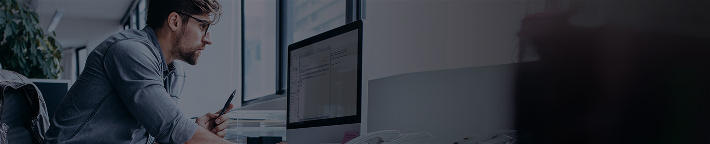 Person leaning over desktop computer.